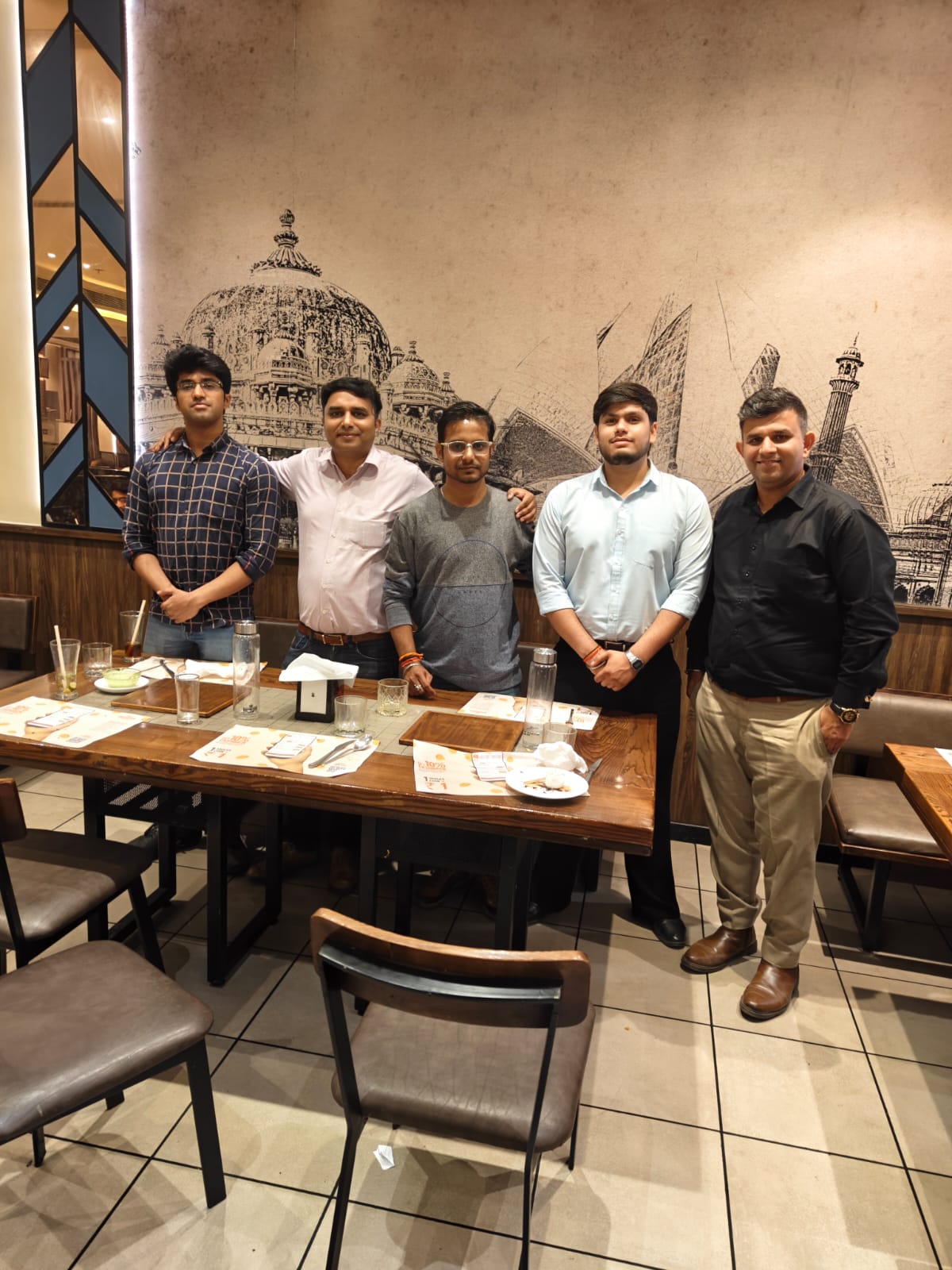 Team dinner at restaurant with Mughal art decor